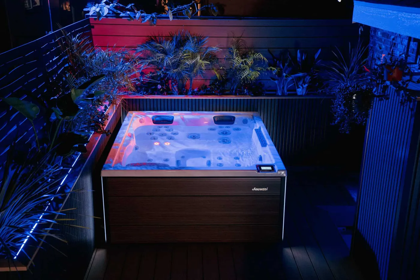 Jacuzzi® hot tub lit up at night