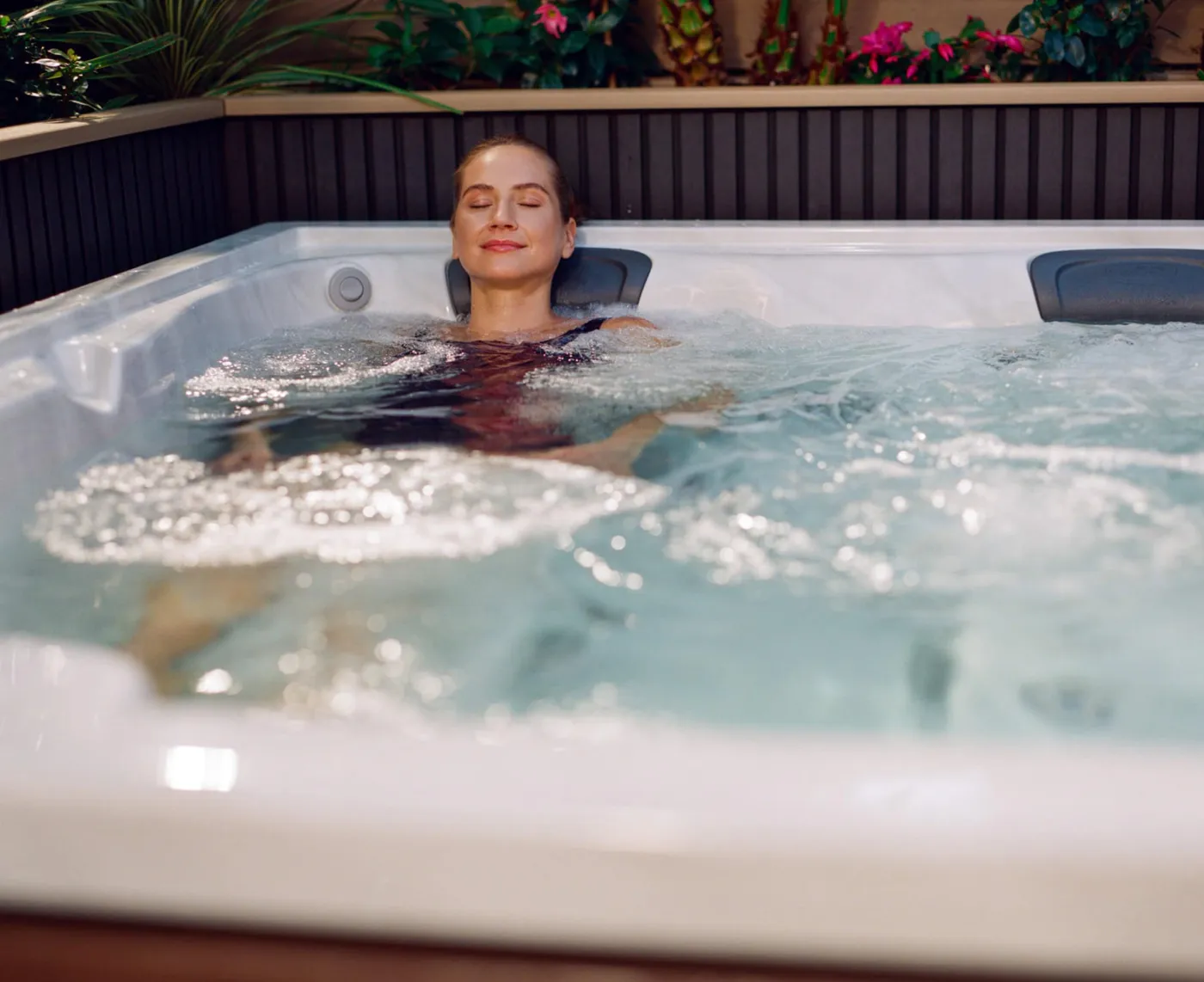 Woman enjoying hydrotherapy jets in a Jacuzzi® hot tub